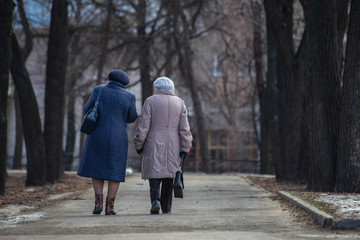 older women are walking down the street