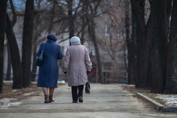 older women are walking down the street