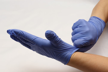 Fototapeta na wymiar Blue gloves on hand. Syringe with a needle. Preparation for the injection of the drug.