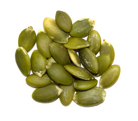 A handful of green pumpkin seeds on a white background