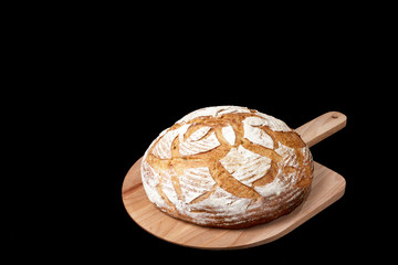 Handmade yeast-free bread on black background. Angle view  with space for your text.