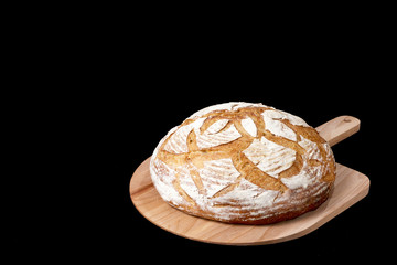 Handmade yeast-free bread on black background. Angle view  with space for your text.