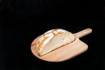 Handmade yeast-free bread on black background. Angle horizontal view  with space for your text.