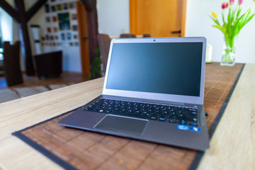 A clean laptop stands on a table