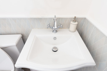 White luxury sink in bathroom, Modern hygienic wash basin with running clean water.