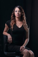 Studio shoot of beauty woman posing on the chair