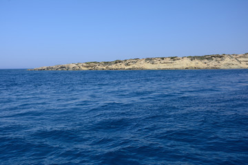 view from the sea on the rocky coast