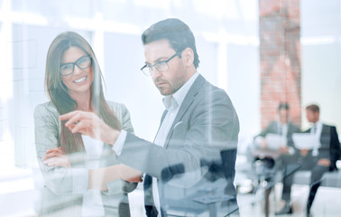 business people discussing something while standing in the office