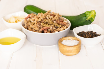 Ingredients. recipe step by step fusilli pasta with zucchini on white wood