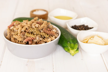 Set of ingredients. recipe step by step fusilli pasta with zucchini on white wood