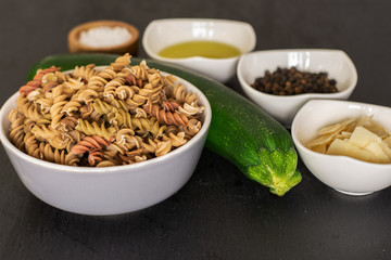 Ingredients. recipe step by step fusilli pasta with zucchini on grey stone