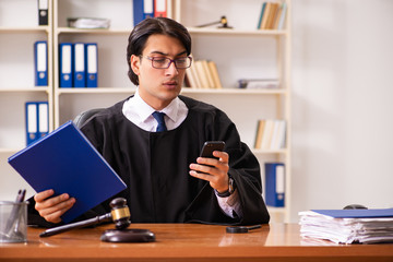 Young handsome judge working in court