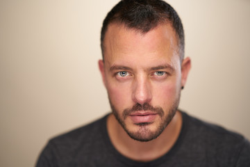 Fototapeta premium Portrait of Handsome man with blue eyes and short hair in studio