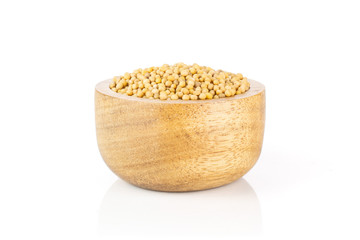 Lot of whole white mustard seeds with wooden bowl isolated on white background