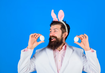 Rabbit man. Easter mask. Preparation for Easter. Religion. Easter man. Bearded man with white eggs in hands. Spring holiday. Easter spirit. Symbolic food. Tradition coloring eggs. Holiday bunny ears.