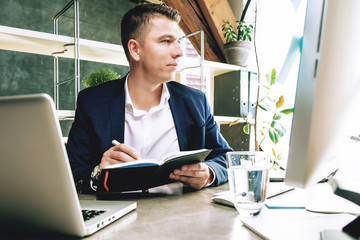 Business man working at office with laptop and documents on his desk