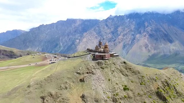 Flying around group of hikers tourists over mountain range Aerial 4k video. Hiking Travel Tourism Caucasus Svaneti, Georgia.