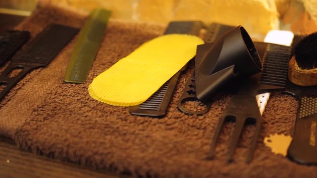 Table with scissors and trimmers at the barber shop, making of haircuts, straight razor on the table, shaving salon