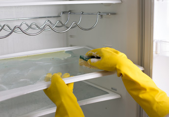 Woman cleaning refrigerator