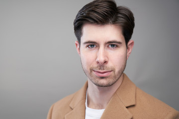 Portait of handsome man with short black hair in studio, caucasian