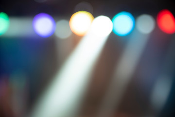 Abstract colorful defocused background, light spotlights on party