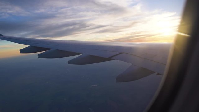 air travel to other countries. beautiful sunset from the plane window. wing out the window. travelling by plane.