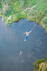 Extreme jump from the bridge. The man jumps surprisingly quickly in bungee jumping at Sky Park...