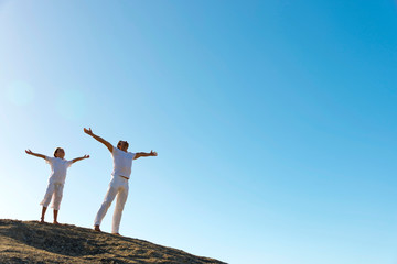 Father and son breathing on top of hill