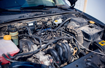 Close-up photo of car engine in car mechanic shop. Car repair concept.