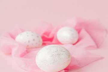 Fototapeta na wymiar White Easter eggs on pink background with copy space. Top view shot of arrangement decoration Happy Easter holiday background concept. Design pastel tone in minimal flat lay