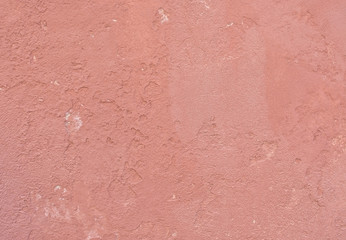 Grungy red roughcast wall