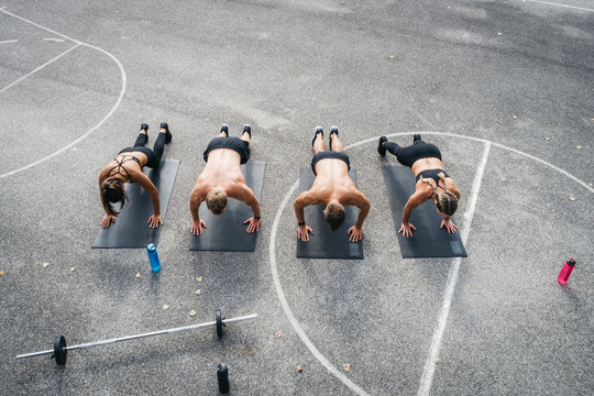 Sporty team during workout, pushups