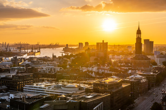 Germany, Hamburg, Hamburg Harbor and St. Michaelis Church at sunset