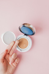 Swatch of foundation on the hand on pink background, cosmetic Cushion on girl's hand, beauty and fashion concept