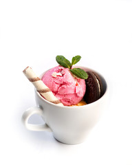 Ice cream decorated with mint and sweets in a cup on an isolated white background