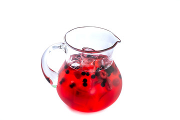 Berry red lemonade in a jug on an isolated white background