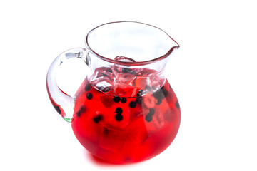 Berry red lemonade in a jug on an isolated white background