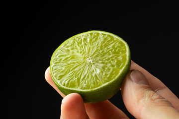 Half lime in the hand of a man.