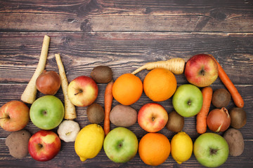 Healthy lifestyle - fruits and vegetables on wooden background