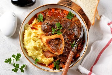 Beef shank stew with onions, carrots, celery, tomatoes, thyme and wine. Top view.