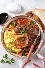Beef shank stew with onions, carrots, celery, tomatoes, thyme and wine. Top view.