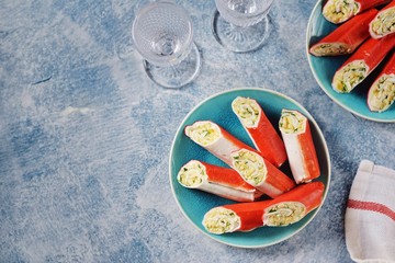Crab sticks stuffed with soft cheese, boiled egg, garlic, mayonnaise and dill. Festive Russian snack. Top view.  © chudo2307