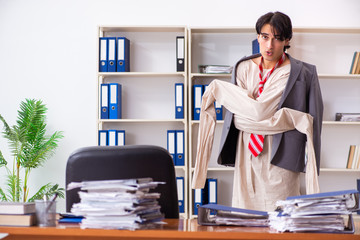 Crazy young man in straitjacket at the office