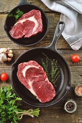 Raw fresh beef steak rib eye on old wooden background. Rustik Style. Top view.