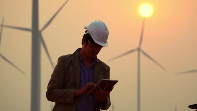 Senior Engineer, Asian are monitoring system wind turbine electricity generation with teblet footage 4K