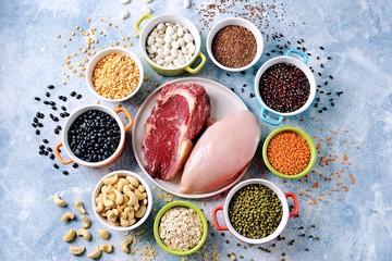 Red lentils, peas, black, white and red beans, nuts - the concept of healthy vegetarian food. Top view. 