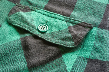 Close up of breast pocket on green black vintage flannel plaid shirt      