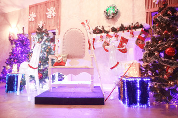 chair for Santa Claus and boxes with gifts in a cozy living room