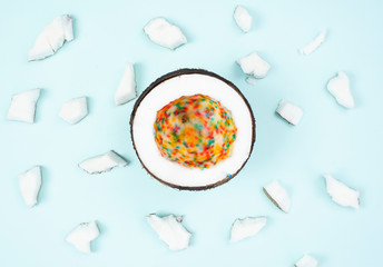 half multicolored coconut on blue background