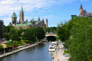 Looking down a boat lined Rideau Canal towards Parliament Hill, Ottawa, Ontario, Canada - obrazy, fototapety, plakaty
